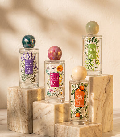 Pristine Forests face mist bottles on marble, morning light